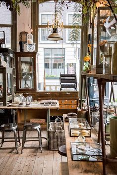 a room filled with lots of different types of furniture and decor on top of wooden floors