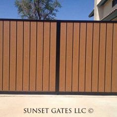 the sunet gates inc logo is shown in front of a gate with brown panels