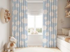 a child's bedroom with blue and white curtains, teddy bear on the window sill