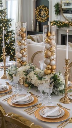 a table set for christmas with gold and white decorations