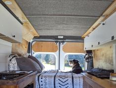 a dog sitting in the back of a camper