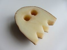 an apple sliced in half on a white surface