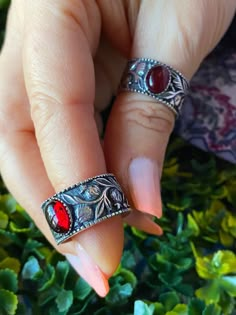 "Hand carved, intricate pomegranate vines wrap around the sterling silver band with bezel set simulated garnet. The color of the gemstone is a red wine color. The band is open on the back and can fit almost any finger size. This one of a kind ring will make a perfect gift for yourself or anyone who values handcrafted, quality items. Ring is adjustable and can fit sizes 6-10. It will look great on index, middle and ring fingers and even as a thumb ring. Be gentle and let the band warm up a little Dope Jewelry, Thumb Rings, Jewelry Inspo, Sterling Silver Bands, Pretty Jewellery, Ring Sterling Silver, Bracelet Stack, Adjustable Ring, Cute Jewelry