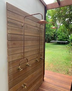 an outdoor shower in the middle of a wooden deck