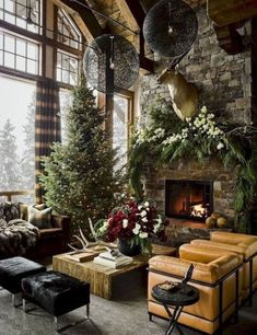 a living room filled with lots of furniture and christmas decorations on the wall above it