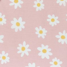 a pink background with white daisies and yellow centers