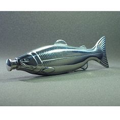 a silver fish figurine sitting on top of a table