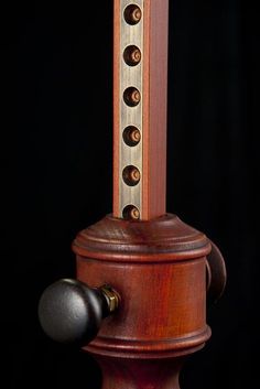 a wooden object that is on display in the dark