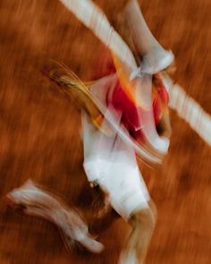 a blurry image of a tennis player on the court