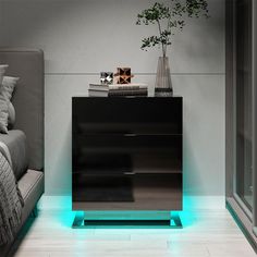 a black night stand with blue lights on the sides and a plant next to it