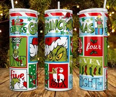 three christmas themed tumblers sitting on top of a wooden table next to a tree