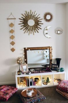 a living room filled with lots of furniture and mirrors on the wall above it's shelves