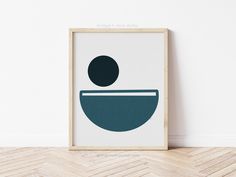 an art print with a bowl on the bottom and a black dot in the middle