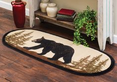 a bear rug is on the floor next to a potted plant and bookshelf