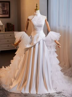 a white wedding dress on display in a room