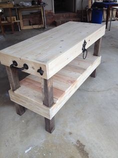 a coffee table made out of wood with two drawers on each side and one shelf below it