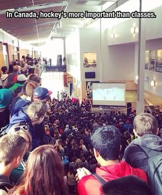 a crowd of people standing in an airport