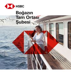 a woman standing on the deck of a boat looking at her cell phone while seagulls fly overhead