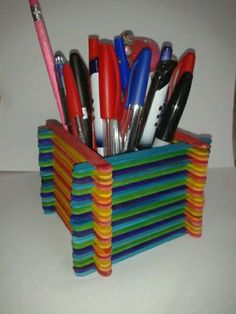 a stack of pens and pencils in a holder