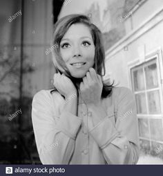 an old black and white photo of a woman with her hands on her neck - stock image