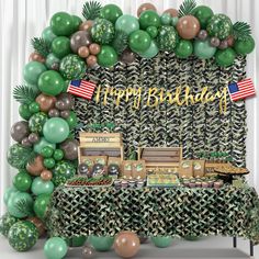 a birthday party with green and brown balloons, palm trees, and an american flag