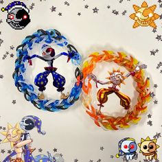 two bracelets with cartoon characters on them sitting next to each other in front of stars