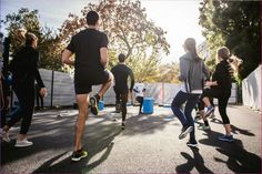 a group of people are running on the street