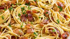 pasta with bacon and parsley in a white bowl