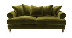 a green couch with four pillows on it's back and one arm facing the camera