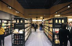 people are standing in the aisle of a grocery store