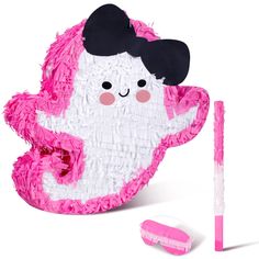 a pink and white stuffed animal next to a toothbrush