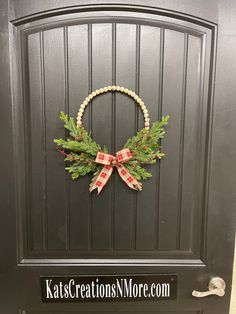 a christmas wreath on the front door of a house