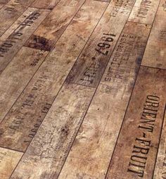 an old wooden floor with many different types of words written on the wood planks