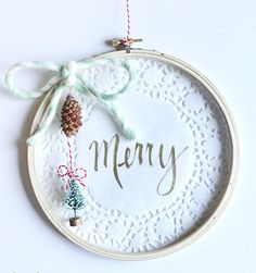 a christmas ornament hanging on a wall with the word merry written in it