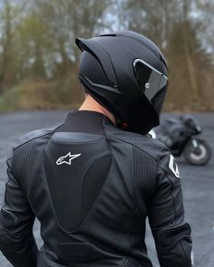 a man wearing a black leather jacket and helmet