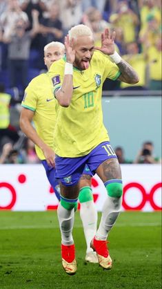 the soccer player is celebrating his goal in front of an excited crowd as he walks on the field