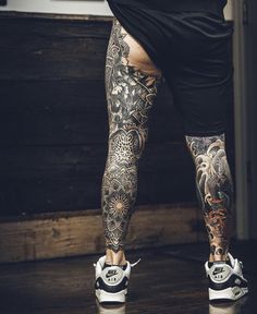 a person with tattoos on their legs and feet