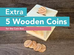 wooden coins sitting on top of a table with the title extra 5 wooden coins for the coin box