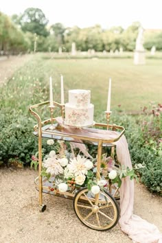 a wedding cake sitting on top of a cart