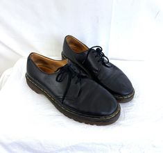 Great vintage Doc Marten shoes - made in England.  Soles are in great shape MADE IN ENGLAND UK Size 10 See measurements to be sure of proper fit.  Sole length: 12 1/4" Width of sole at ball: 4 1/2" Vintage Low-top Oxfords For Workwear, Vintage Oxfords With Leather Footbed And Closed Toe, Vintage Black Leather Shoes With Stitched Sole, Vintage Low-top Oxfords With Stitched Sole, Vintage Low-top Leather Shoes With Stitched Sole, Vintage Black Low-top Oxfords, Vintage Black Oxfords With Leather Footbed, Vintage Black Leather Shoes With Round Toe, Doc Marten Shoes