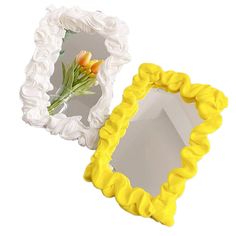 two decorative mirrors with flowers in them on a white background, one is yellow and the other is white