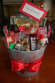 a metal bucket filled with candy and snacks