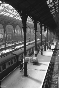 an old train station with people waiting for their trains