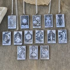 nine tarot cards are displayed on a table next to a rock and some other items