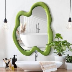 a bathroom with a sink, mirror and plants