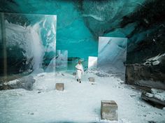 a person standing in the middle of an ice cave