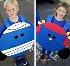 two children dressed up in costumes standing next to each other