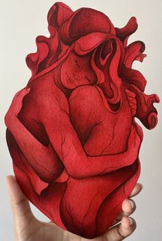 a drawing of a human heart being held by someone's hand