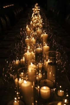 a long table with many lit candles on it