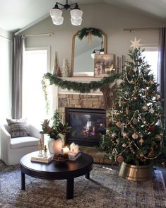 a living room filled with furniture and a christmas tree in front of a fire place